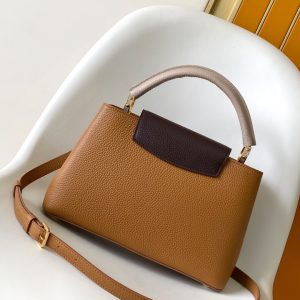 Alternative view of p125031.05 x 20.0 x 11.0 cm (L x H x W)27.0 x 17.3 x 9.0 cm (L x H x W)21.0 x 13.6 x 8.0 cm (L x H x W)•Taurillon calf leather•Calf leather trim•Cowhide leather lining•Metal hardware•Flap can be positioned inside or outside•Zippered interior pocket•Interior patch pocket•Metal studs•Holds smartphone, LV Vertical wallet, headphones, and keys•Shoulder strap: Detachable, adjustable•Strap half-length: 45.5 cm•Strap half-length adjustable to: 53.0 cm•Handle: Single handle